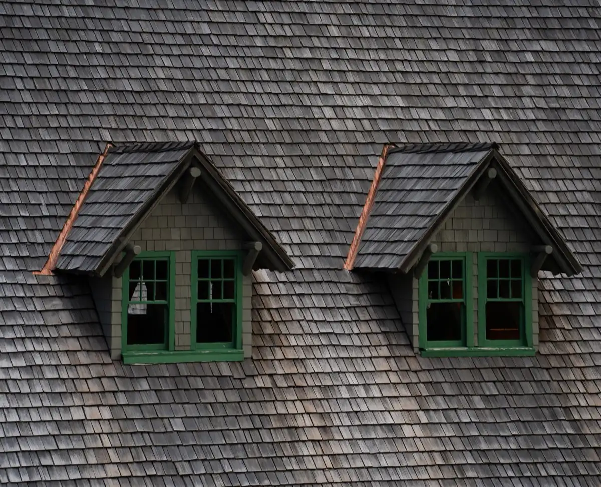 Dormers on a shingle roof in Burleson, TX, where step flashing and kickout flashing carry water past the walls